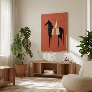 Folk art print of a figure in a wide-brim hat riding a tall dark horse with a tan saddle blanket on a warm terracotta background, vertical mid century equestrian wall art.