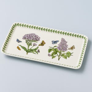 May include: Rectangular serving tray with a cream-colored surface, featuring botanical illustrations of purple flowers and butterflies. The tray has a green vine border and is suitable for serving food or as a decorative piece.