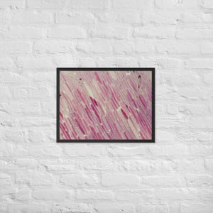 May include: Framed abstract art print featuring a close-up view of a microscopic image. The artwork displays a pattern of elongated, pink and white shapes, with darker red accents, set against a light background. The frame is black.