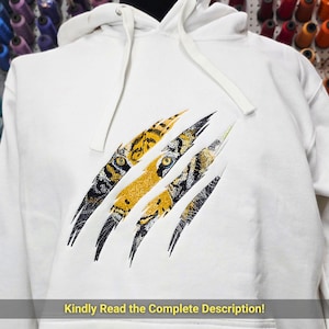 May include: White hooded sweatshirt with a tiger claw design. The design features yellow, black, and white claw marks with tiger eye details. The text at the bottom reads, "Kindly Read the Complete Description!"