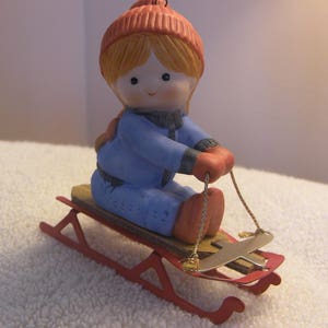 Enesco Country Cousins Ceramic Girl on Wooden Sled Holiday Ornament