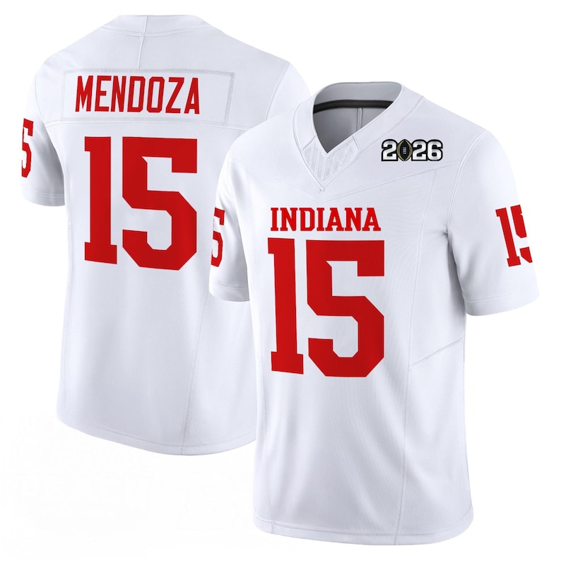 May include: White football jersey with red lettering and numbers. The jersey features "INDIANA" and the number "15" on the front, and "MENDOZA" and "15" on the back. The year "2026" is printed on the upper chest.
