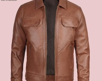 May include: A brown leather jacket with a collared neckline, two chest pockets, and two side pockets. The jacket has a zipper closure and the text "VINTAGE HIDE APPAREL" is visible in the upper left corner.
