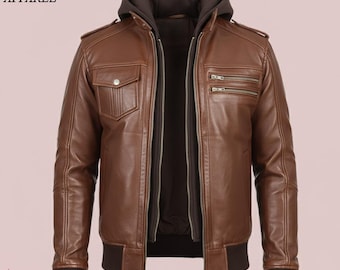 May include: Brown leather jacket with a detachable hood and multiple zippered pockets. The jacket features a ribbed hem and cuffs, and the text "VINTAGE HIDE APPAREL" is visible in the upper left corner.