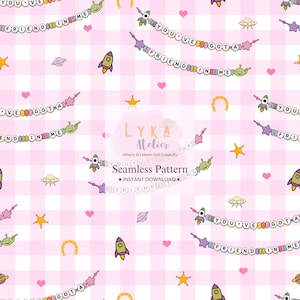 May include: A seamless pattern featuring a pink and white checkered background with cartoon rockets, aliens, planets, stars, and hearts. The text "YOU'VE GOT A FRIEND IN ME" is displayed on a banner. The design includes the text "LYKA Atelier" and "Seamless Pattern".