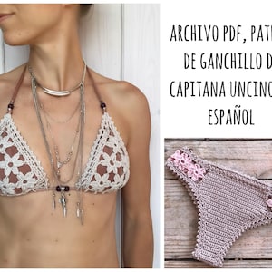 May include: A crochet bikini top and bottom in a light brown color with pink floral accents. The top is a triangle style with a delicate crocheted pattern. The bottom is a high-waisted style with a similar crocheted pattern. The text "ARCHIVO PDF, PATRON DE GANCHILLO DE CAPITANA UNCINO EN ESPAÑOL" is visible in the image.