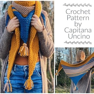 May include: A triangular crochet shawl with stripes of mustard yellow, beige, and blue. The shawl has tassels on each end. The crochet pattern is by Capitana Uncino.