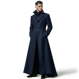 May include: A floor-length, dark blue wool-textured overcoat featuring a high collar, long sleeves, and a single-breasted front closure with silver-toned buttons. The coat has a structured fit with a flared skirt and is worn over black trousers.
