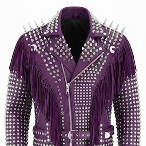 May include: A purple leather jacket with silver metal studs and spikes. The jacket has fringe on the sleeves and chest, a belted waist, and a zip closure. The collar and shoulders are adorned with large, pointed spikes.