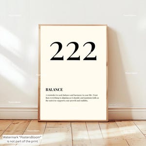 May include: A framed print with the number "222" in bold black font at the top. Below, the word "BALANCE" is printed, followed by a reminder to seek balance and harmony in life. The print is in a light cream color.