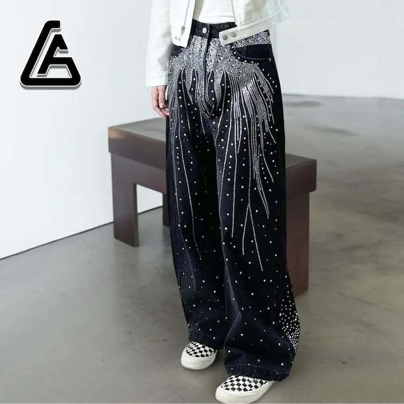 Unisex Rhinestone Pants | Wide Leg Studded Jeans | Glitter Streetwear Fashion Bottoms
.
Wide-leg black pants decorated with cascading rhinestones and glitter stud details shown in a studio setting.