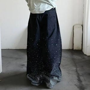 Unisex Rhinestone Pants | Wide Leg Studded Jeans | Glitter Streetwear Fashion Bottoms
.
Wide-leg black pants decorated with cascading rhinestones and glitter stud details shown in a studio setting.