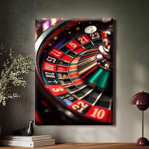 May include: A close-up of a roulette wheel canvas print. The wheel features red and black numbered pockets, with a green section. The image is framed and mounted on a wall above a wooden cabinet.