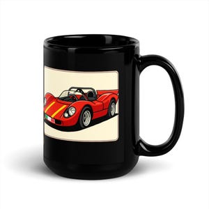 May include: Black ceramic mug featuring a red vintage race car illustration with yellow stripes and an Italian flag. The car is set against a cream-colored background. The mug has a large handle.