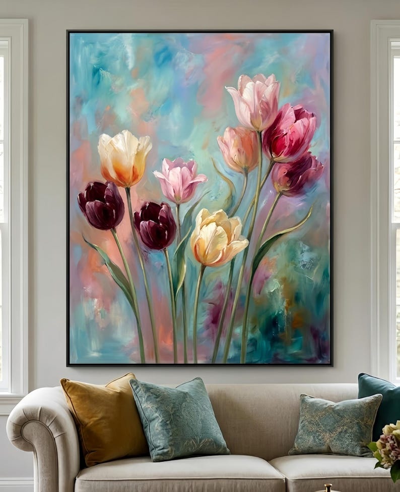 May include: A large framed painting featuring a bouquet of tulips in various colors, including deep burgundy, yellow, and pink. The background is a blend of blue, pink, and green hues, creating a soft, artistic effect. The painting is displayed above a beige sofa.