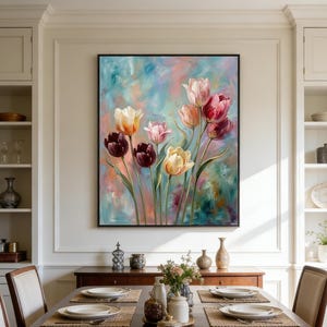 May include: A framed floral painting featuring colorful tulips in shades of pink, yellow, and burgundy against a soft, blended background of blue, pink, and peach. The artwork is displayed above a wooden dining table.