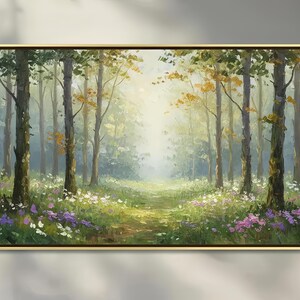 May include: A rectangular landscape painting in a thin gold frame depicting a sunlit forest clearing. Tall tree trunks rise from a grassy floor covered in patches of white and purple wildflowers, with soft light filtering through the canopy.