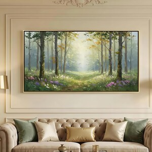 May include: A rectangular landscape painting in a thin gold frame depicting a sunlit forest scene with tall trees, green foliage, and patches of white and purple wildflowers on the forest floor, rendered in a soft, painterly style with light.