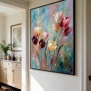 May include: A framed floral painting featuring colorful tulips in shades of pink, red, yellow, and purple against a textured, abstract background of blue, pink, and green. The artwork is displayed on a white wall.
