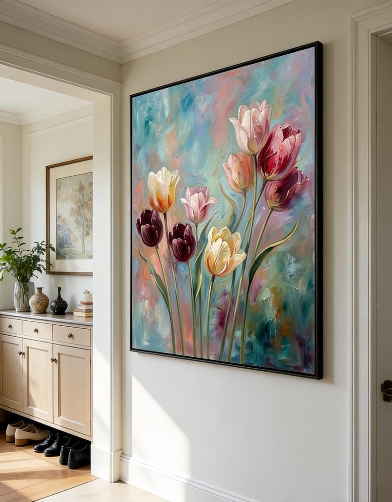 May include: A framed floral painting featuring colorful tulips in shades of pink, red, yellow, and purple against a textured, abstract background of blue, pink, and green. The artwork is displayed on a white wall.