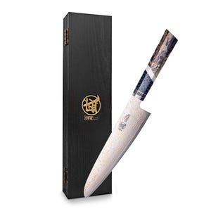 May include: A Japanese-style chef's knife with a patterned blade and a decorative handle. The knife is displayed next to a black wooden box with gold accents. The blade has a unique wave-like pattern.