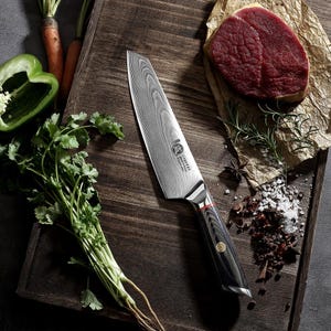 May include: A Damascus steel chef's knife with a black and wood grain handle, red accent, and a silver bolster. The knife is on a wooden cutting board with a raw steak, herbs, spices, and vegetables. Culinary and kitchen tools.