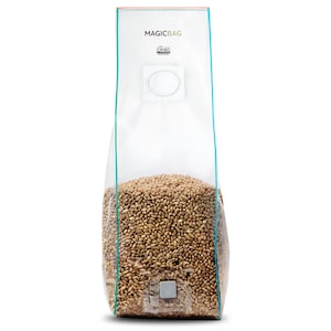 May include: A clear plastic bag labeled "MAGICBAG" filled with brown grains. The bag has a white square and circle design, with a teal border. The bag is filled with grains, and the bottom of the bag has a square design.