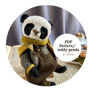 May include: A handmade teddy panda with a white face, black eyes and ears, and a brown nose. The panda wears a mustard-colored scarf and overalls. The text "PDF Pattern/ teddy panda 6" / 15 cm" is visible.