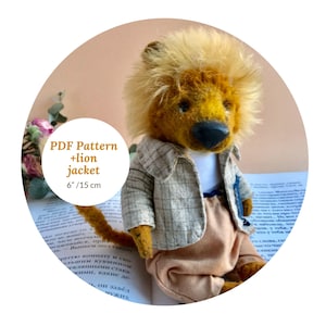 May include: A handmade lion plush toy, approximately 6 inches (15 cm) tall, with a tan and brown mane, wearing a plaid jacket and tan pants. The text "PDF Pattern + lion jacket" is visible.