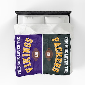 May include: A split-design duvet cover featuring a purple side with yellow text reading THIS SIDE LOVES THE VIKINGS and a football labeled MN, and a dark green side with yellow text reading THIS SIDE LOVES THE PACKERS and a football labeled GB.