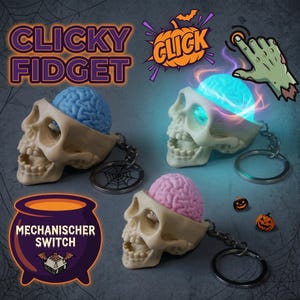Könnte beinhalten: Drei schädelförmige Fidget-Schlüsselanhänger mit freiliegenden Gehirnen in Blau und Pink. Ein Gehirn leuchtet hellblau. Der Text lautet CLICKY FIDGET, CLICK und MECHANISCHER SWITCH. Enthält einen Metallring mit Spinnennetz-Anhänger und zwei Kürbisperlen.