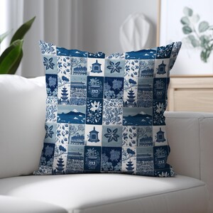 May include: A square throw pillow featuring a blue and white patchwork design. The pattern consists of repeating rectangular tiles displaying illustrations of pagodas, floral motifs, mountain landscapes, and traditional architectural structures.