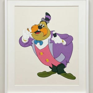 May include: Framed illustration of a cartoon character in a purple suit, pink waistcoat, and blue bow tie. The character has a large orange moustache and is holding a black object. The artwork is set against a cream background.