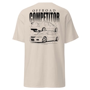 May include: Beige t-shirt featuring a black graphic of two race cars with the text "OFFROAD COMPETITOR" above them. The cars are detailed with lines, and the shirt has a classic crew neck.
