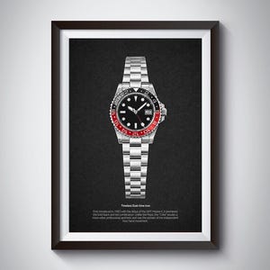 K&ouml;nnte beinhalten: Gerahmter Druck einer Edelstahl-Uhr mit schwarzem Zifferblatt und rot-schwarzer L&uuml;nette. Die Uhr ist auf einem dunkelgrauen Hintergrund zentriert. Der Text unten lautet "Timeless Dual-time Icon".