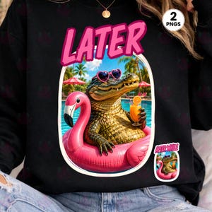 May include: Black sweatshirt with a graphic of an alligator wearing heart-shaped sunglasses, floating on a pink flamingo float in a pool. The alligator holds a drink. The word "LATER" is above the image in pink.
