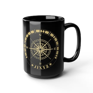 May include: A black ceramic mug featuring a gold-colored compass rose graphic on the front. The design includes cardinal directions N, S, E, and W, along with the text JIXYZ positioned at the bottom of the circular compass emblem.