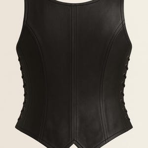 May include: A sleeveless black corset top featuring a structured bodice with vertical seam detailing and side panels with black lace-up grommet closures. The garment has a scoop neckline and a pointed hemline at the front center.