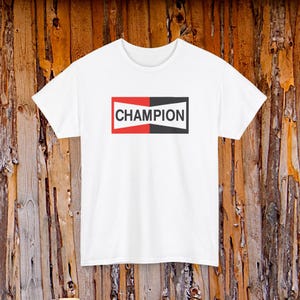 May include: White t-shirt with a Champion logo. The logo is a rectangle divided in half, with red on the left and black on the right. The word "CHAMPION" is in white, centered within the rectangle.
