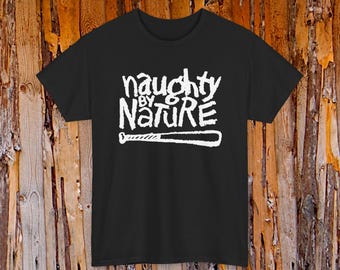 May include: Black t-shirt with the white text "naughty by nature" and a baseball bat graphic. The text is in a stylized, graffiti-like font. The shirt is made of a soft material and has a crew neck.
