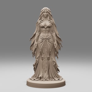 May include: A light brown monochromatic figurine of a standing figure wearing a long, flowing gown with tattered edges, a detailed bodice, and a crown. The figure has long hair and stands on a circular base, presented in a neutral studio setting.