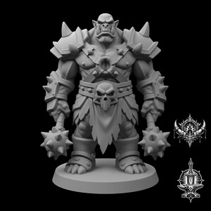 May include: A grey, unpainted miniature figurine of a muscular orc warrior standing on a circular base. The figure wears spiked shoulder armour, a chest harness with a central ring, and a loincloth featuring a prominent skull emblem.