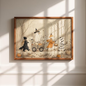 May include: A framed illustration in a wooden frame depicting a black cat, a white bird in a witch hat, a fox in an orange coat, and a striped figure pulling a wooden wagon filled with pumpkins through a forest with scattered pumpkins.