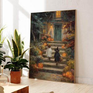 May include: A rectangular wall art print featuring an oil painting of two children in costumes walking up stone steps toward a house entrance at night. The scene is decorated with numerous glowing orange pumpkins, autumn foliage, and warm porch lights.