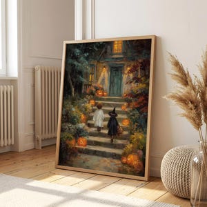 May include: A framed wall art print depicting a dark, painterly scene of two children in costumes walking up stone steps toward a house entrance at night, surrounded by glowing orange jack-o'-lanterns, autumn foliage, and warm golden light.