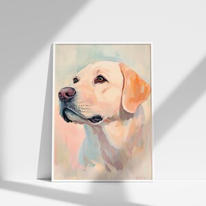 May include: A framed watercolor painting of a yellow Labrador Retriever dog. The dog is depicted in profile, with a soft, pastel color palette of cream, peach, and light blue. The dog's eyes are brown, and the nose is pink.