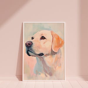 May include: A framed watercolor painting of a yellow Labrador Retriever. The dog is depicted in profile, with a soft, pastel color palette of cream, peach, and light blue. The dog's eyes are brown, and the nose is pink.