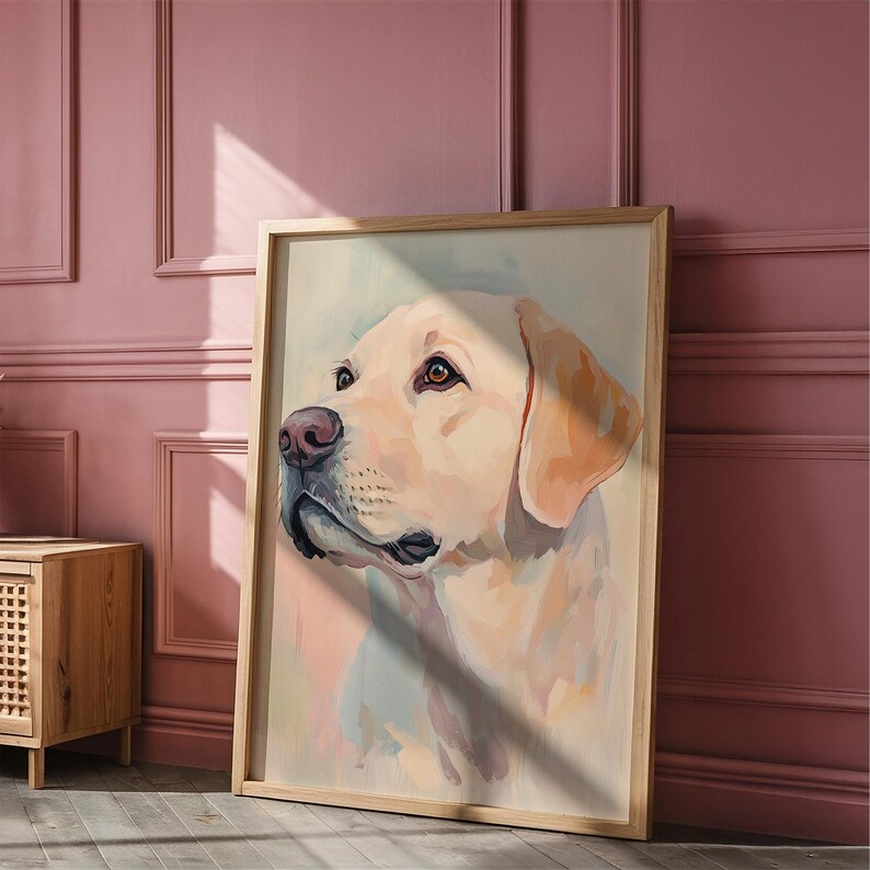 May include: A framed art print of a yellow Labrador Retriever dog. The dog's head is turned to the side, with a soft, watercolor-like painting style. The frame is made of light-colored wood.