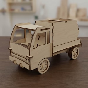 Peut inclure: Un camion jouet en bois avec un design détaillé. Le camion comprend une cabine avec des sièges, une zone de chargement et des roues. La couleur naturelle du bois lui donne un aspect classique. Le camion jouet est posé sur une surface marron.