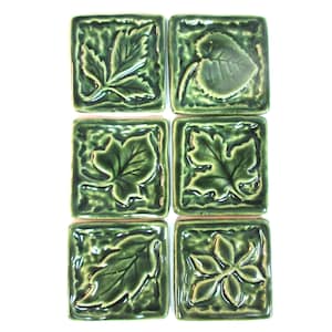 May include: Six green ceramic tiles with embossed leaf designs. Each tile features a different leaf shape, creating a botanical pattern.